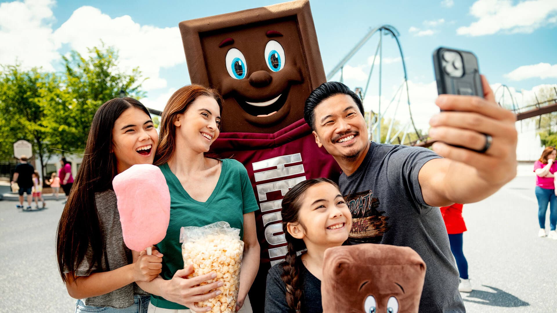 family taking selfie with hershey bar character hersheypark