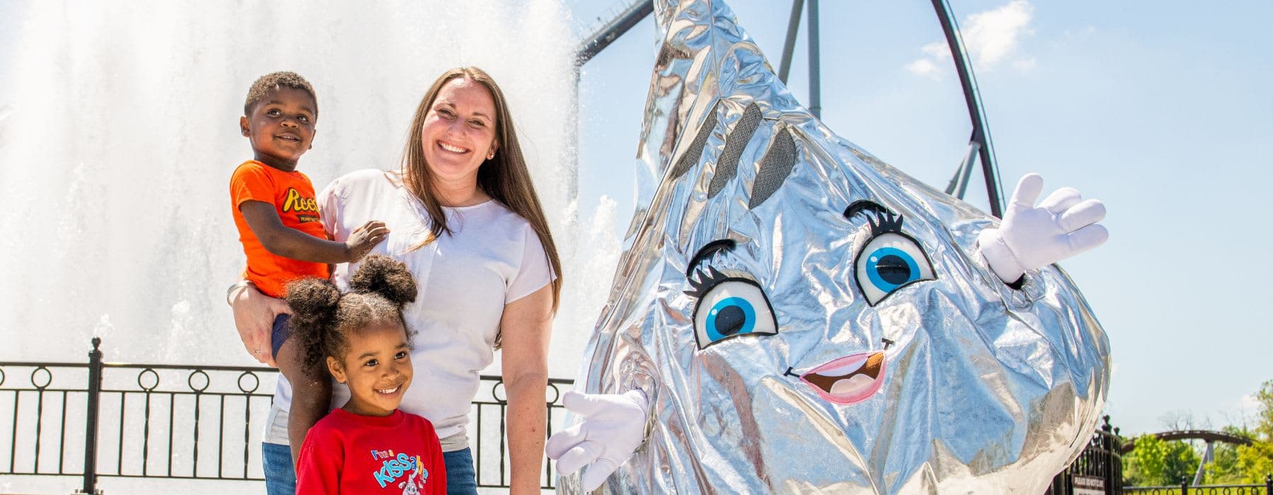 Hershey's Kiss Character at Hersheypark celebrating with happy children