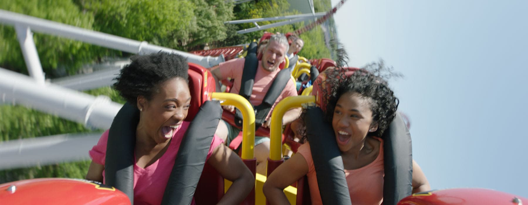 Two girls sitting front row on Storm Runner