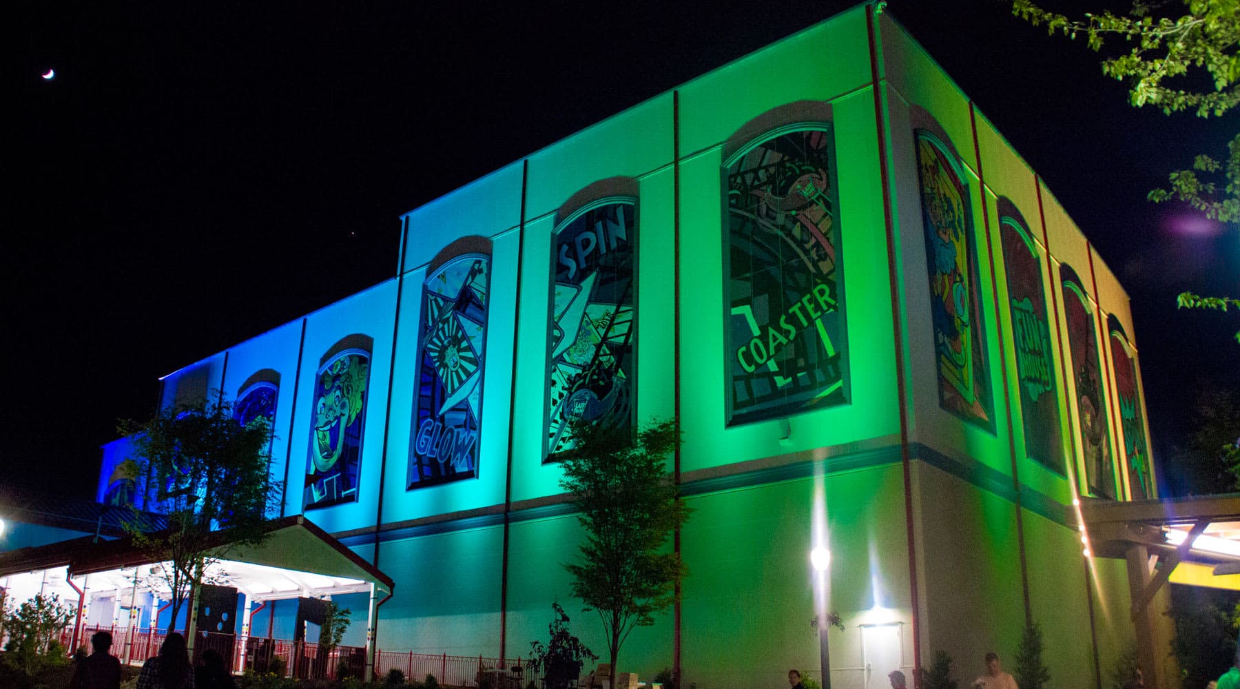 Laff Trakk Coaster Exterior at Night with Blue and Green lights illuminating the sides