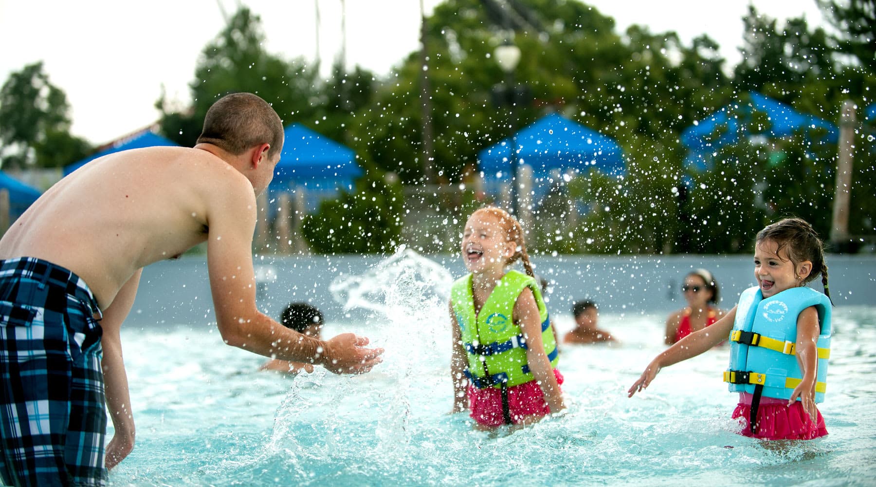 Dad Splashing 2 Daughters in Life Vests at The Shore water Attraction at Hersheypark