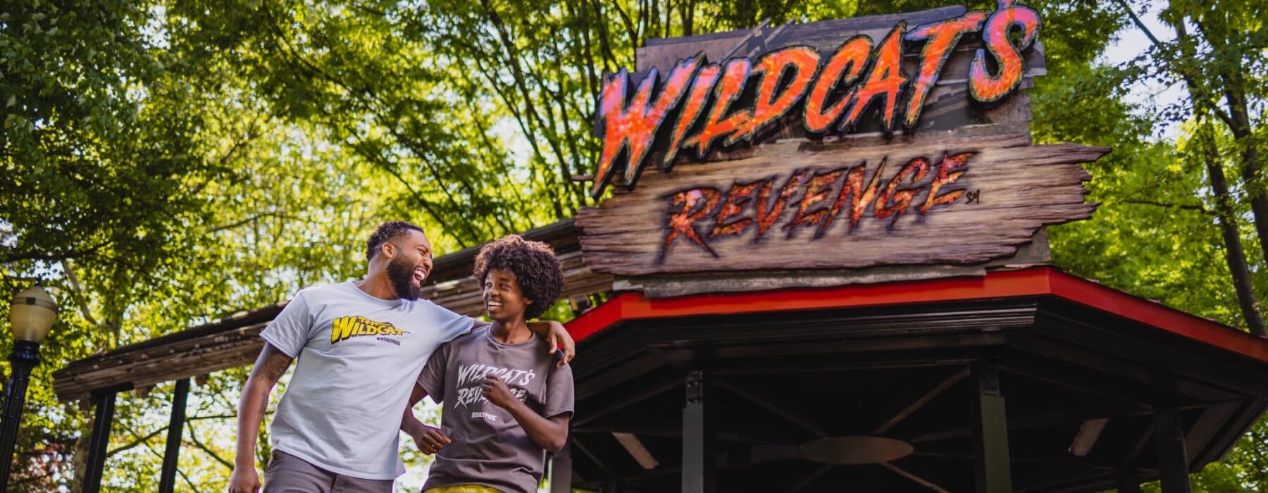 Father and son standing in front of the WIldcat's Revenge sign in Hersheypark