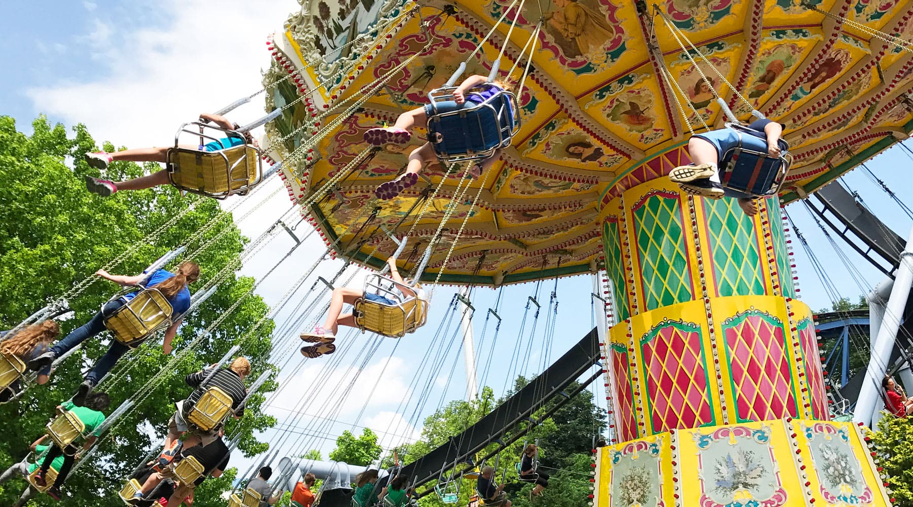 people riding wave swinger ride