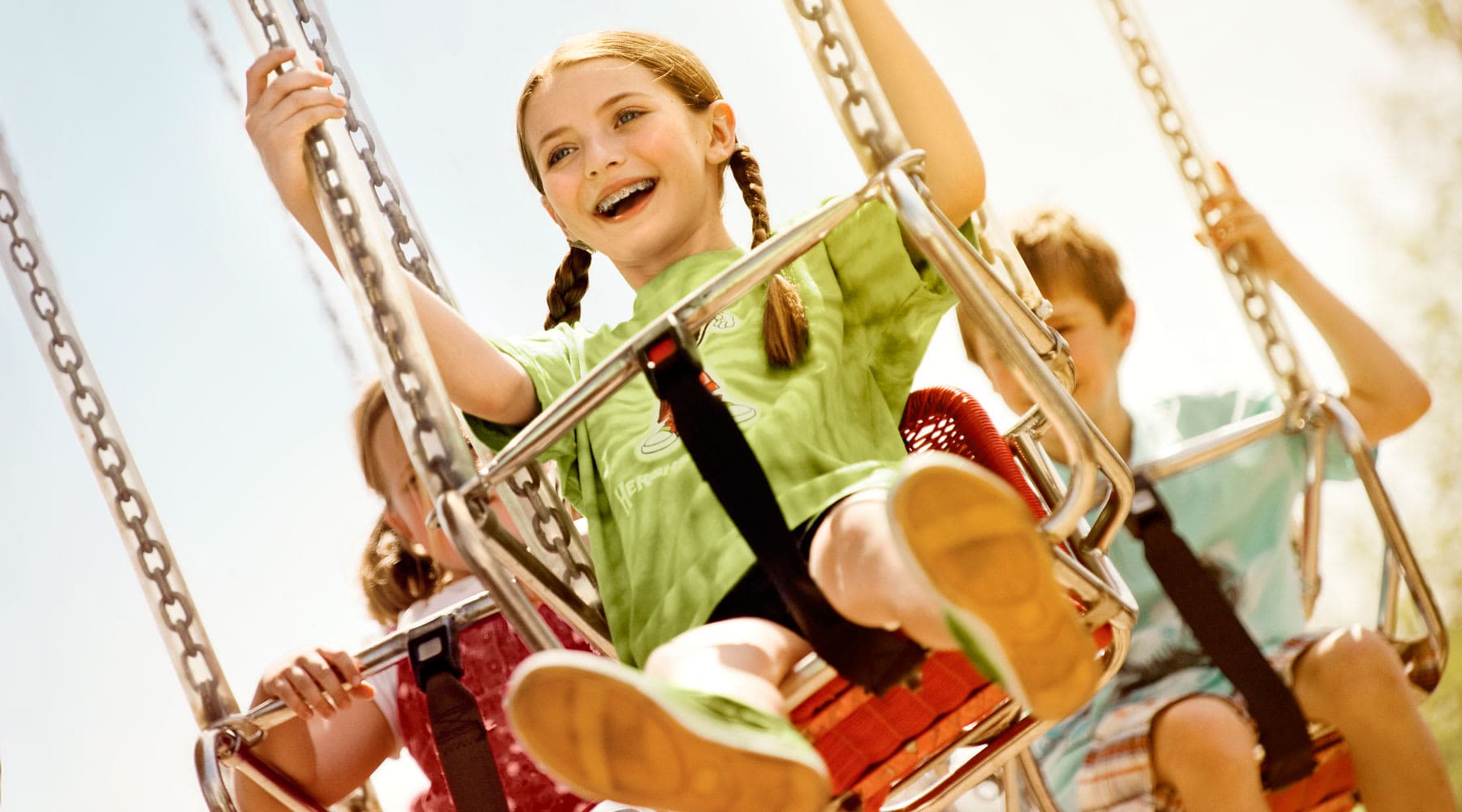 Girl with Braces and Pigtails Smiling on the Wave Swinger Ride 