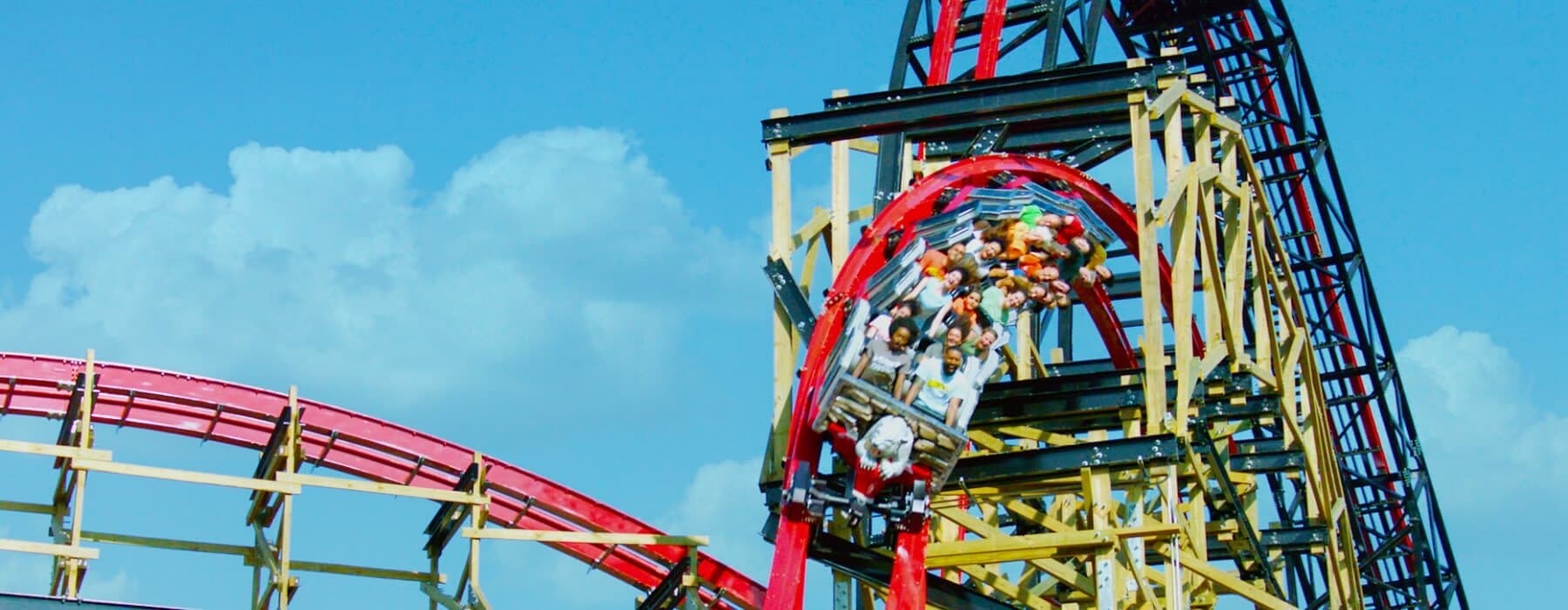 Still shot of group of guests riding Wildcat's Revenge together on a sunny day