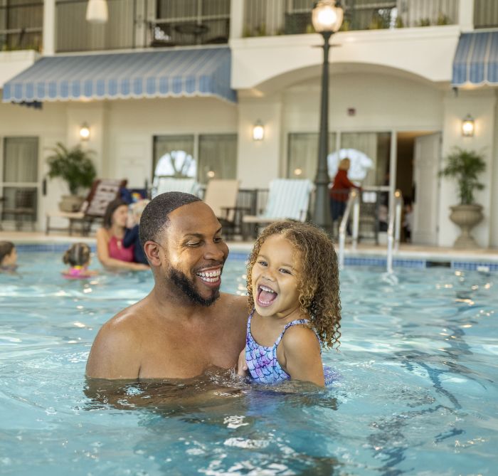 Father and daugther swimming at the indoor pool at The Hotel Hershey