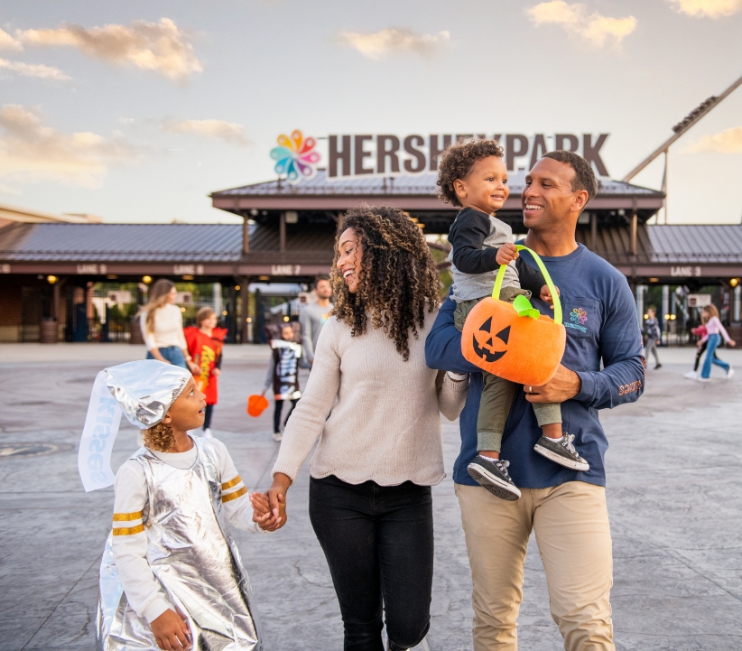 Family of four with two small children walking inside of Hersheypark