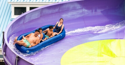 Family riding on Breakers Edge water slide at The Boardwalk at Hersheypark