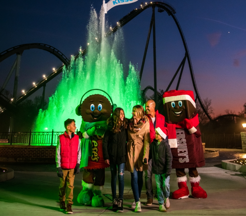 Family of four with two small children walking inside of Hersheypark