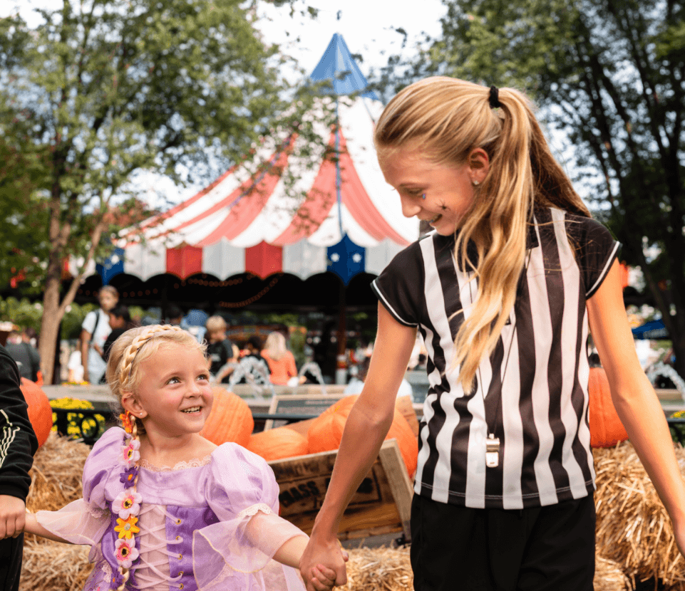 A woman and a young girl walking through Hersheypark